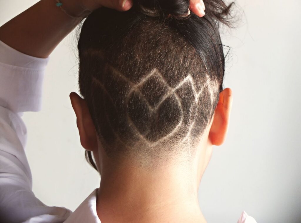 Close-up of a geometric undercut hairstyle with intricate patterns, showcasing unique fashion style.